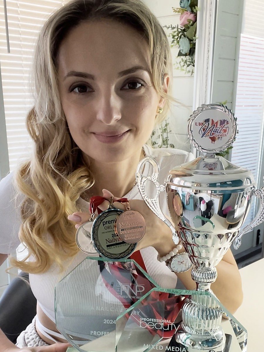 Diana Vig, founder of Diana Vig Nail Academy, with her competition trophies